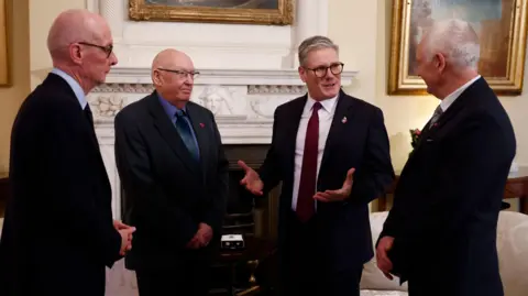 PA Media Prime Minister Sir Keir Starmer (second right) and Chancellor of the Duchy of Lancaster Pat McFadden (left) with Elizabeth Emblem campaigners Bryn Hughes (right) and Paul Bone (second left) in 10 Downing Street.