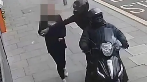 Handout photo issued by Metropolitan Police of a phone snatching incident in London.