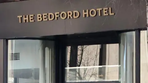 The picture shows the front sign of the Bedford Hotel in Belfast