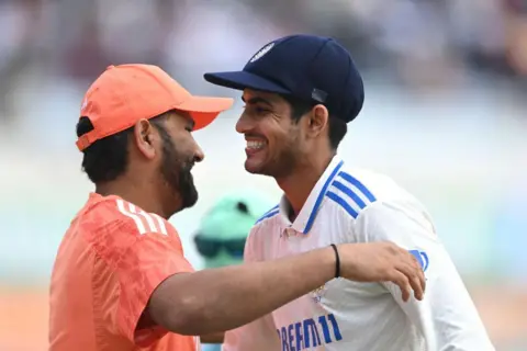 Getty Images India batsmen Shubman Gill is congratulated by captain Rohit Sharma after India win the test match and the series after day four of the 4th Test Match between India and England at JSCA International Stadium Complex on February 26, 2024 in Ranchi, India.
