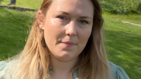 A head and shoulder shot of Gaia Pope's cousin Marienna Pope-Weidemann, who has long blonde hair and is wearing a pale blue top
