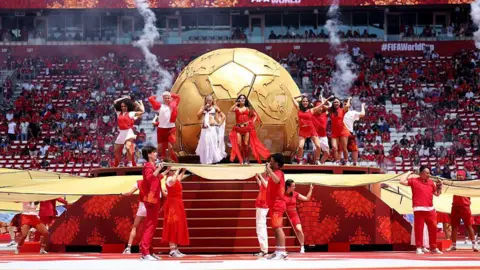 Getty Images A elephantine  golden  shot    shot  and performers dressed successful  red