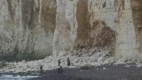 Richard Weston People gathered by the bottom of a cliff