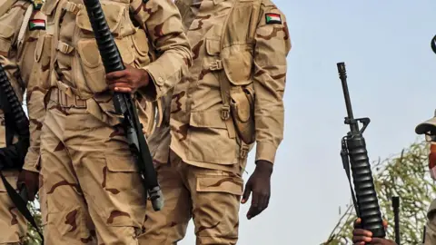 A close-up of the uniforms of Sudanese soldiers and guns at the Wadi Seidna air base in Omdurman in 2020.