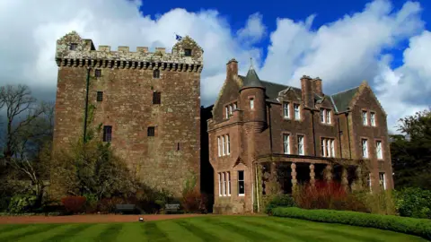 Jay Wingfield A side view of Comlongon Castle with the Tower House and mansion beside it with sweeping lawns in front