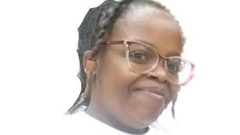 Rose Njeri, in glasses and white T-shirt
