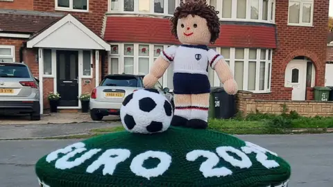 Sue Cockroft/Your Herefordshire The postbox topper featuring a footballer and football on a green layout with Euro 2024 lettering