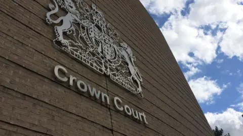 Outside view of Cambridge Crown Court, showing a close up of the sign 