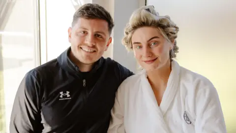 Kennedy News Ashleigh Stanley and childhood sweetheart Jake Stanley. They are dressed in casual clothes at their wedding 