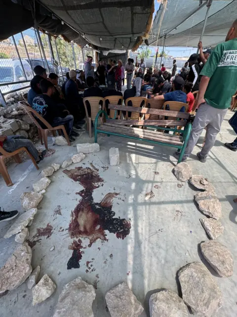 Oren Rosenfeld/BBC A bloodstain remains at the spot where Odeh Hathaleen was killed in Umm al-Khair in the occupied West Bank