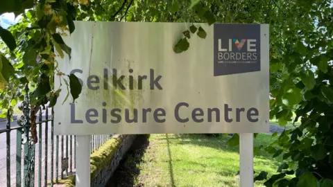 A sign among trees reading Selkirk Leisure Centre