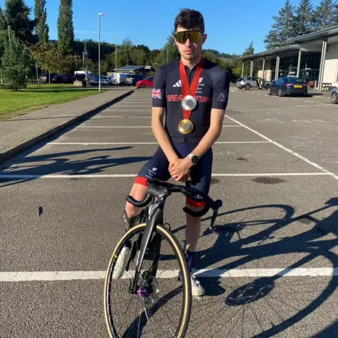 Cyclist Fin Graham on his bike and wearing sunglasses