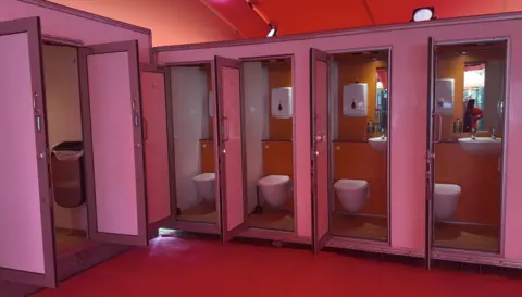 George King/BBC A row of clean toilet cubicles. 