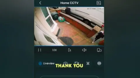 Facebook A screenshot of the doctored doorbell footage, with a yellow caption saying 'thank you' over it