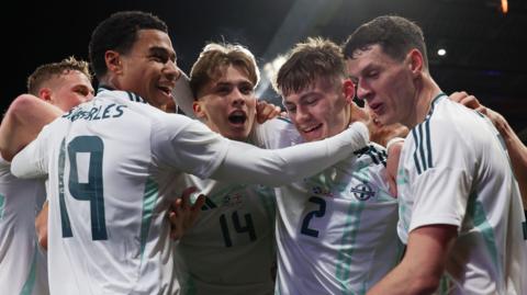 Northern Ireland players celebrate Conor Bradley's goal against Scotland