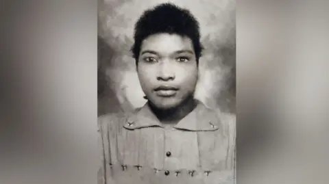 Supplied The photograph shows a black and white photo taken of Louise Garvey aged 16 when she arrived in England. 