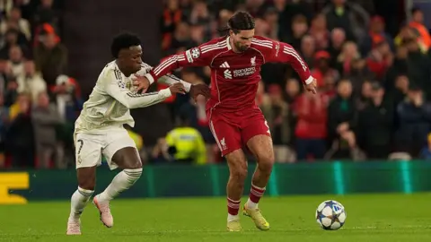 Dominik Szoboszlai and Vinicius Junior battle for the ball at Anfield