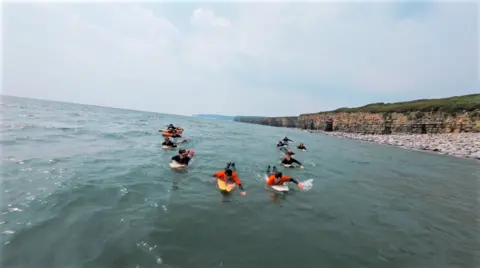 Fine Rolling Media Mark paddling home to Llantwit Major with his surfing friends