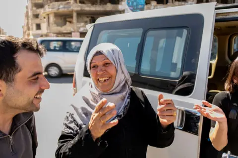 Fatima Hazzouri stands outside a mini-van