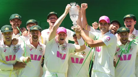 Steve Smith and Pat Cummins of Australia hold up The Ashes trophy after the Fifth Test in the 2025/26 Ashes Series between Australia and England at Sydney Cricket Ground