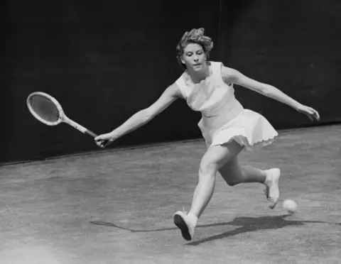 Getty Pericoli returns a forehand service  successful  a achromatic  dress, mid movement