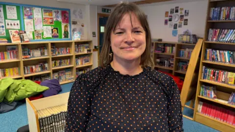 A teacher sitting in a school library