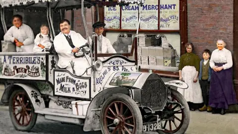 Edwin Williams The same restored image shows the black and white signage on the car and the smiling people much more clearly