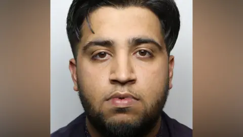 Mugshot of Sohail Jahangir who has black hair and a beard.