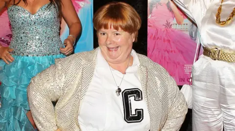 Magda Szubanski in character on a red carpet as Sharon 