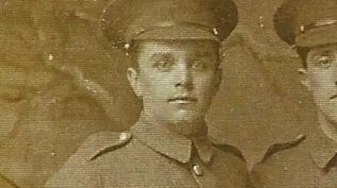 Wheatley Hill History Club A sepia close-up photo of Albert Dove who is wearing a military uniform with a hat. Another man can be seen on the right but has been cropped out of the photo.