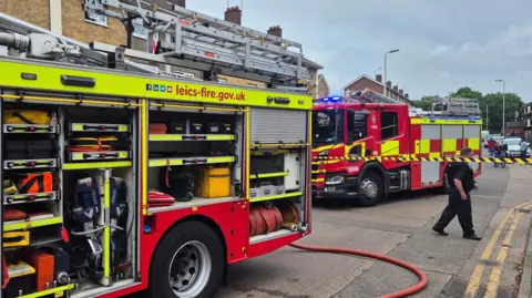 Leicestershire Fire and Rescue Service Firefighters and fire engines at the scene on Manitoba Road