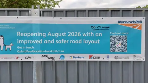 A Netwrok rail banner by the Botley Road tunnel which reads "reopening August 2026 with an improved and safer road layout"