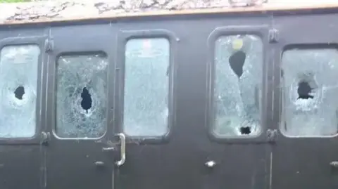 Five smashed windows on a carriage on the Lavender Line.