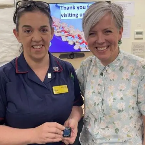 Birmingham Women's Hospital Alison Rea and Kate Brintworth smile at the camera while Ms Rea holds her award