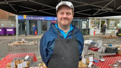 Alex Pope/BBC James Honour on a market stall in Bedford