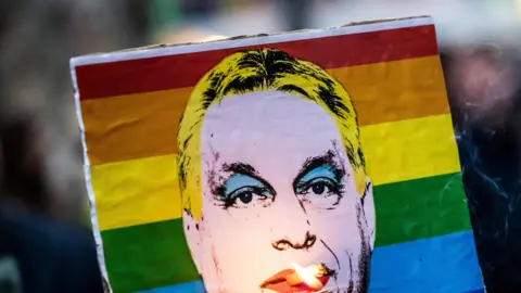 A pro-LGBT placard depicting Hungary's Prime Minister Viktor Orban
