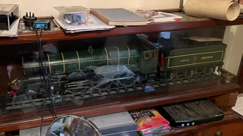 Thames Valley Police Green model locomotive in a wooden and glass case.