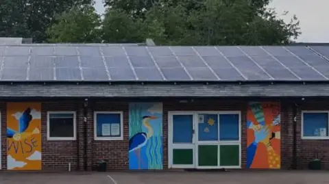 St Barnabas Primary School Murals on the side of the school building depicting an owl, a heron and a set of hands.