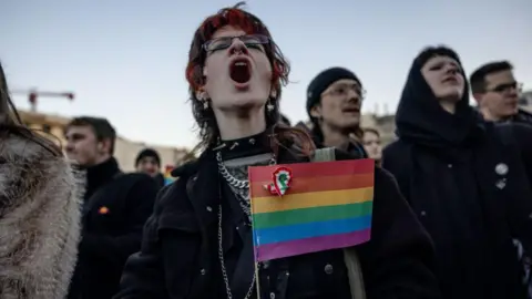 Protester in Budapest holds a rainbow flag after Hungary bans Pride marches