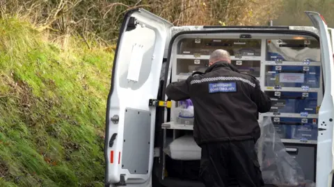 Derbyshire Police Derbyshire Police officer at the scene collecting evidence