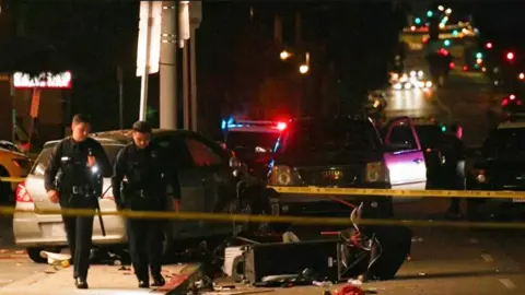 Emergency services at the scene of an incident in Los Angeles involving a car reportedly driving into a crowd of people