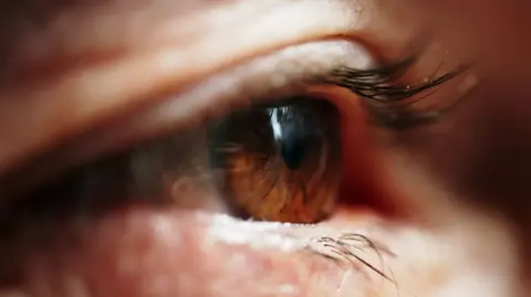 Getty Images A close up of a person's brown eye.