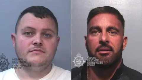 South Wales Police Two mugshots of men side by side. They both have short dark hair and facial hair. The one on the left is wearing a white t shirt. The one on the right is wearing a black jacket. They ar eboth looking dorectly into the camera with neutral expressions.