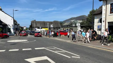 People walking into Keswick town centre from the convention site.