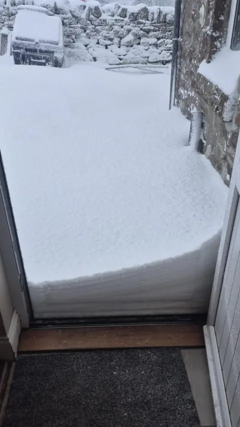 Craig MacNicol A big wedge of snow at someone's doorstep 