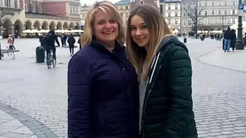 Family Photo Carole Gould, left, stands next to her daughter Ellie Gould in a square in Europe.