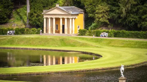 Ken Blackburn Digital Imaging/Supplied A view across a lake and manicured lawns, with stone statues and a Greek temple-style building