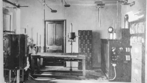 Stroud Hospitals League of Friends A black and white photo showing a room in a hospital with various pieces of equipment.