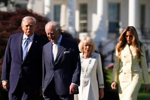 Reuters The couples, all formally dressed, walk together through the White House garden