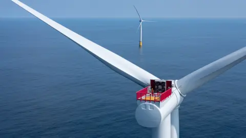 Reuters The rotor of a large wind turbine at sea. The turbine is white and there is a red and yellow platform over the axel with two people in hard hats wearing red on it. In the distance another wind turbine stands in line with it.